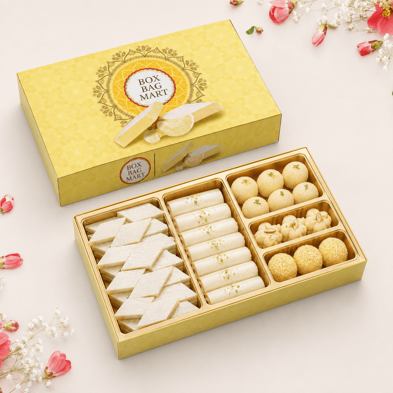 BOX BAG MART yellow floral custom-printed kaju katli sweet packaging box with gold compartments and assorted Indian mithai.
